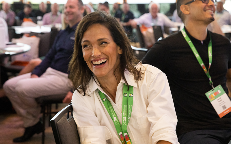 Woman smiling at HIA National Conference event