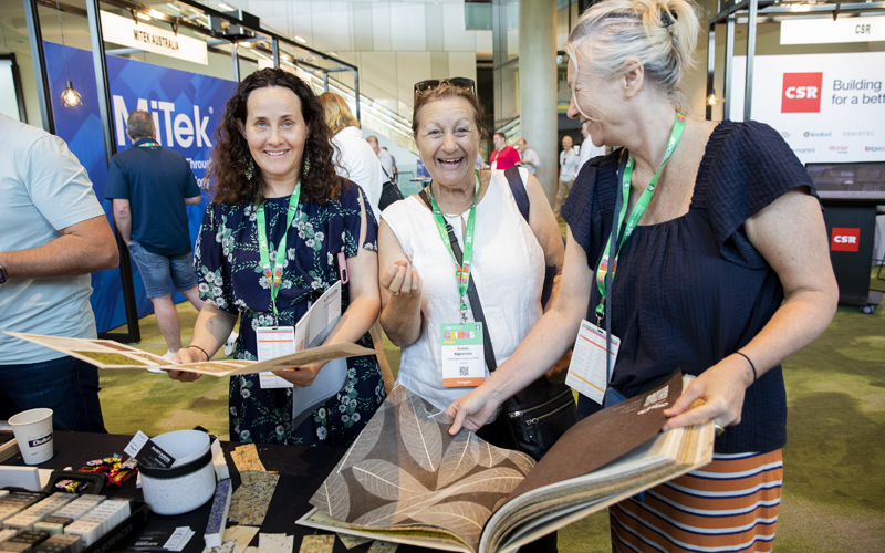 Women talking at HIA National Conference booth